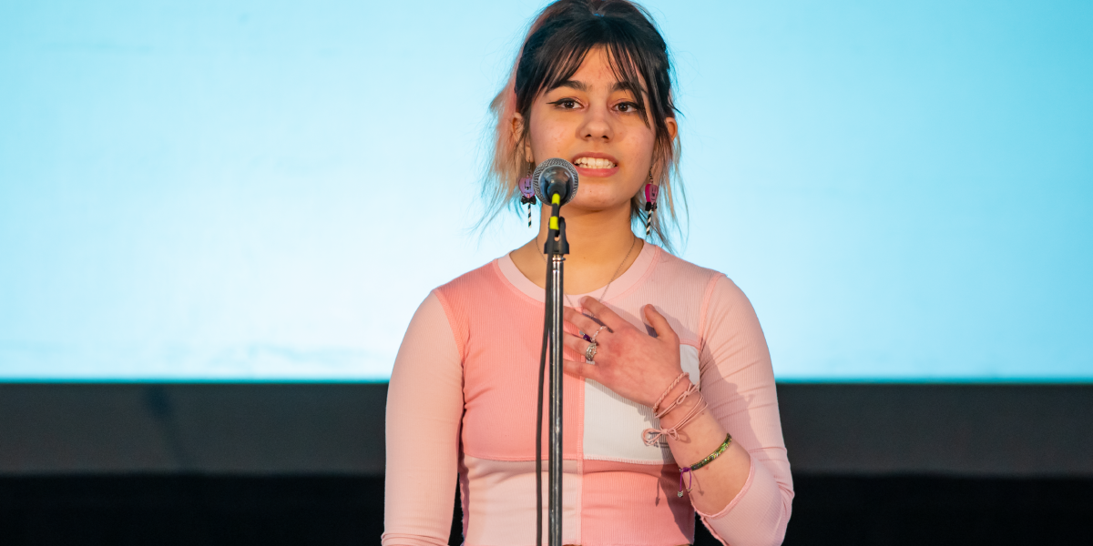 A student performs her poem to an audience at the Rotunda of the Manitoba Legislative Building.